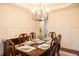 Elegant dining room features wainscoting, stylish chandelier, and set table for hosting dinner at 4025 Toulon Ln, Cumming, GA 30040