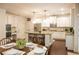 Bright kitchen features white cabinets, stainless appliances, island, and adjacent dining area at 4025 Toulon Ln, Cumming, GA 30040