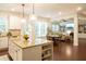 Kitchen features a large granite island and breakfast bar open to a sunny breakfast area at 4025 Toulon Ln, Cumming, GA 30040