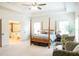 Spacious main bedroom features a tray ceiling, ceiling fan, sitting area, and ensuite bathroom at 4025 Toulon Ln, Cumming, GA 30040