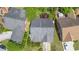 Overhead view of a single-Gathering home featuring a dark grey roof, green yard, and surrounding greenery at 4484 Hunters Way, Stone Mountain, GA 30083