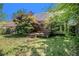 Backyard with a wooden deck and mature trees at 4484 Hunters Way, Stone Mountain, GA 30083