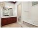 Bathroom showcasing a soaking tub and vanity with a large mirror at 4484 Hunters Way, Stone Mountain, GA 30083