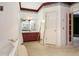 Bathroom featuring a large tub and vanity with ample storage at 4484 Hunters Way, Stone Mountain, GA 30083