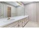 Bathroom featuring an extended vanity with double sinks and cabinets at 4484 Hunters Way, Stone Mountain, GA 30083