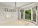 Cozy dining nook with floral wallpaper, chandelier, and bright windows at 4484 Hunters Way, Stone Mountain, GA 30083