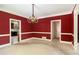 Dining room with chandelier, painted walls and open doorway to other rooms at 4484 Hunters Way, Stone Mountain, GA 30083