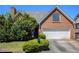 Brick home featuring an attached garage, manicured landscaping and architectural detailing at 4484 Hunters Way, Stone Mountain, GA 30083