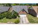 This charming brick home features an attached two-car garage and well-manicured landscaping at 4484 Hunters Way, Stone Mountain, GA 30083