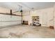 Spacious garage with a roll up door and interior door at 4484 Hunters Way, Stone Mountain, GA 30083