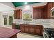 Bright kitchen with dark wood cabinets, stainless steel appliances, and large windows at 4484 Hunters Way, Stone Mountain, GA 30083