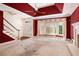 Bright living room featuring a fireplace, staircase, and large window at 4484 Hunters Way, Stone Mountain, GA 30083