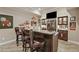 Basement bar with granite countertops, stainless steel appliances, and dark wood cabinetry is perfect for entertaining at 2088 Skybrooke Ct, Hoschton, GA 30548