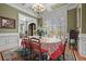 Charming dining room with hardwood floors, wainscoting, and a large window at 2088 Skybrooke Ct, Hoschton, GA 30548
