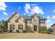 Stunning two-story brick home with stone accents and a beautifully landscaped front yard at 2088 Skybrooke Ct, Hoschton, GA 30548