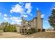 Spacious backyard with brick house featuring a balcony, perfect for outdoor relaxation at 2088 Skybrooke Ct, Hoschton, GA 30548