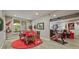 A brightly lit game room featuring a round table, exercise bike, and Georgia Bulldog decor at 2088 Skybrooke Ct, Hoschton, GA 30548