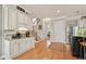 Stylish kitchen with custom cabinets, hardwood floors, and a staircase in the background at 2088 Skybrooke Ct, Hoschton, GA 30548