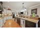 Open kitchen boasts granite countertops, stainless steel appliances, and a breakfast bar overlooking the living area at 2088 Skybrooke Ct, Hoschton, GA 30548