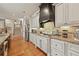 Well-equipped kitchen showcasing custom cabinetry, granite countertops, and stainless steel appliances, seamlessly blending style and functionality at 2088 Skybrooke Ct, Hoschton, GA 30548