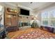 Cozy living room featuring a stone fireplace and hardwood floors at 2088 Skybrooke Ct, Hoschton, GA 30548