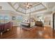 Spacious main bedroom with tray ceilings, recessed lighting, and hardwood floors at 2088 Skybrooke Ct, Hoschton, GA 30548