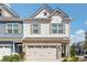 Charming two-story townhouse featuring a brick facade, a two-car garage, and neutral-tone siding at 288 Bahia St, Lawrenceville, GA 30046