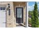 A classic black front door framed by brick and greenery enhances curb appeal at 288 Bahia St, Lawrenceville, GA 30046