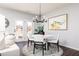 Cozy breakfast nook filled with natural light features a stylish chandelier and access to the backyard at 3034 Cambridge Ml, Acworth, GA 30102