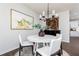 Bright dining area features a stylish chandelier, modern decor, and seamless access to the adjacent kitchen at 3034 Cambridge Ml, Acworth, GA 30102