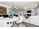 Open-concept living space showcases a modern chandelier, dining area, and a comfortable seating area with a fireplace at 3034 Cambridge Ml, Acworth, GA 30102