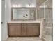 Bathroom with a framed mirror, a shower, and double sinks at 318 Lantana Ln, Woodstock, GA 30188