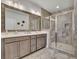 Elegant bathroom features double vanity, large mirror, and a glass enclosed shower with stone tiling at 318 Lantana Ln, Woodstock, GA 30188