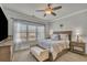 Serene bedroom features a large window, ceiling fan, neutral color palette and carpet at 318 Lantana Ln, Woodstock, GA 30188