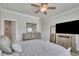 Light-filled bedroom with a TV, a large mirror, and neutral decor at 318 Lantana Ln, Woodstock, GA 30188