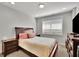 Bedroom with a large bed, a big window, and dark wood furniture at 318 Lantana Ln, Woodstock, GA 30188