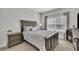 Cozy bedroom featuring neutral tones, a large window, and wood accents at 318 Lantana Ln, Woodstock, GA 30188