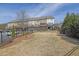 A view of townhomes with fenced yards, landscaping, and a sunny sky at 318 Lantana Ln, Woodstock, GA 30188