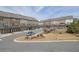 A view of townhomes with garages and decks, set against a backdrop of trees and sky at 318 Lantana Ln, Woodstock, GA 30188