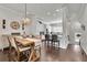 Inviting dining room with hardwood floors, decorative chandelier and adjacent view of the kitchen at 318 Lantana Ln, Woodstock, GA 30188