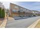 View of townhomes showcasing garages, decks, and a well-maintained street at 318 Lantana Ln, Woodstock, GA 30188