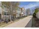 Charming exterior view of townhomes with a walkway, black fence, and well-maintained landscaping at 318 Lantana Ln, Woodstock, GA 30188