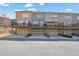 View of multiple townhomes with garages and decks, showcasing the neighborhood's architecture at 318 Lantana Ln, Woodstock, GA 30188