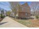 Exterior side view of a townhome featuring a brick facade, well-kept lawn, and black metal fence at 318 Lantana Ln, Woodstock, GA 30188