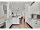 Bright open concept kitchen and dining area with granite counters and white cabinets at 318 Lantana Ln, Woodstock, GA 30188