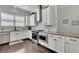 Modern kitchen features granite counters, stainless appliances and tiled backsplash at 318 Lantana Ln, Woodstock, GA 30188