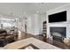 Open concept living space features hardwood floors, fireplace and an adjacent dining area at 318 Lantana Ln, Woodstock, GA 30188