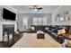 Cozy living room with fireplace, large sectional couch, neutral carpet and filled with natural light at 318 Lantana Ln, Woodstock, GA 30188