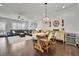 Open concept living and dining area with hardwood floors and modern lighting at 318 Lantana Ln, Woodstock, GA 30188