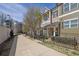 Beautiful street view of modern townhomes featuring manicured lawns and tree-lined street at 318 Lantana Ln, Woodstock, GA 30188